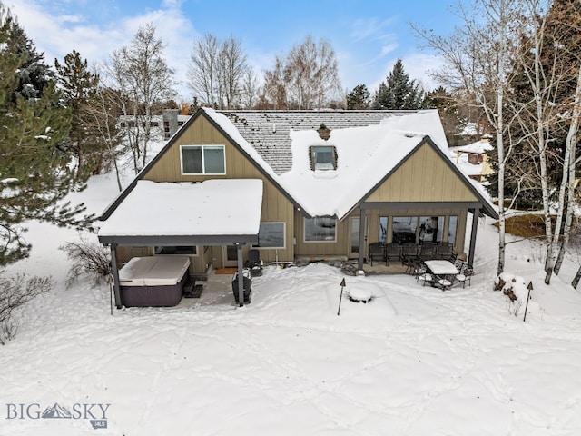 9 Park Plaza Rd, Bozeman, MT 59715 - snow covered back of property featuring board and batten siding and a hot tub