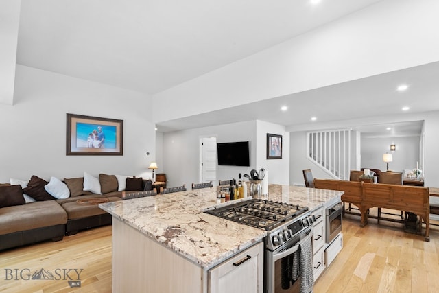 9 Park Plaza Rd, Bozeman, MT 59715 - kitchen featuring recessed lighting, open floor plan, light wood finished floors, and appliances with stainless steel finishes