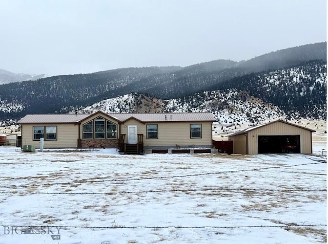 single story home featuring a mountain view and a garage