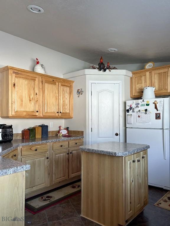 kitchen featuring a kitchen island and white refrigerator