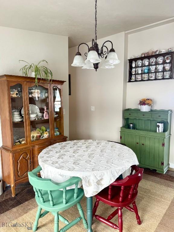 carpeted dining room featuring a chandelier