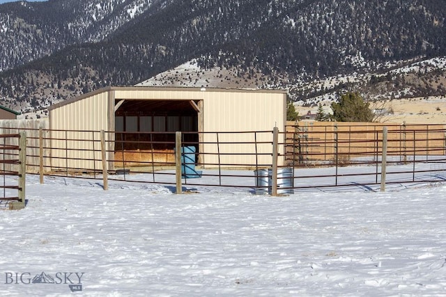 view of stable featuring a mountain view