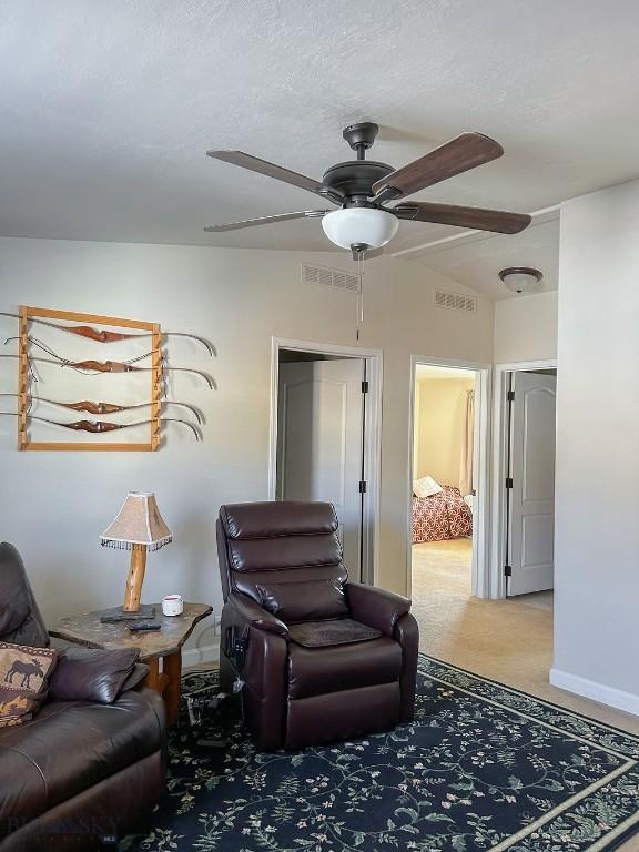 living room featuring carpet flooring and ceiling fan