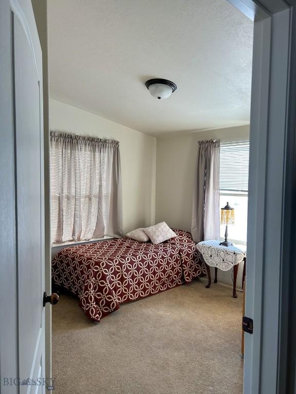 carpeted bedroom featuring a textured ceiling