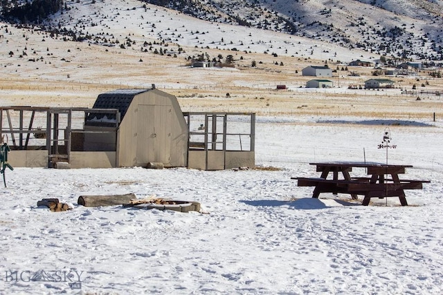 yard covered in snow with a mountain view