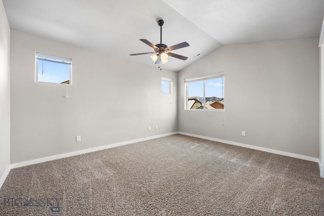 unfurnished room featuring lofted ceiling, carpet floors, a ceiling fan, and baseboards