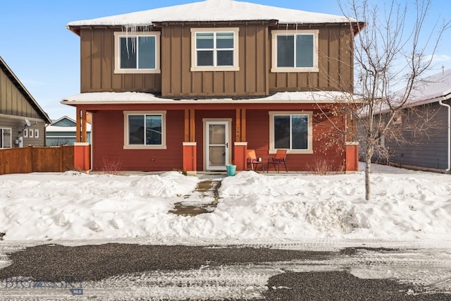 view of front of property featuring covered porch, fence, and board and batten siding