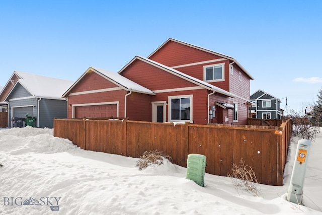 traditional-style house with fence and an attached garage