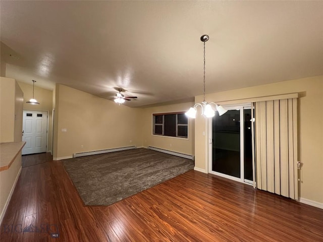 unfurnished dining area with ceiling fan, a baseboard heating unit, and dark hardwood / wood-style floors