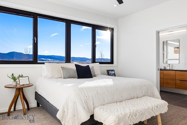 bedroom with a mountain view and ceiling fan