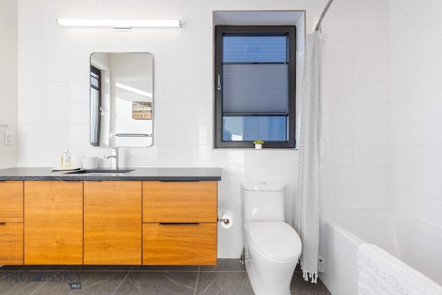 full bathroom with tile walls, toilet, vanity, and shower / bath combination with curtain