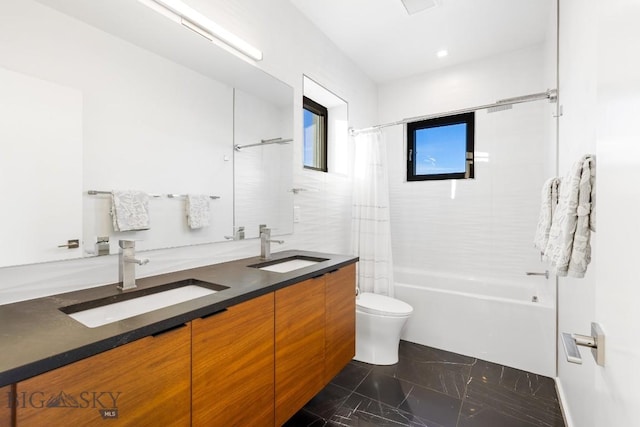 full bathroom featuring toilet, vanity, and shower / bath combo with shower curtain