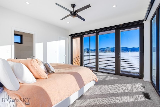 carpeted bedroom with ceiling fan and access to outside