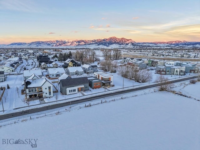 snowy aerial view featuring a mountain view