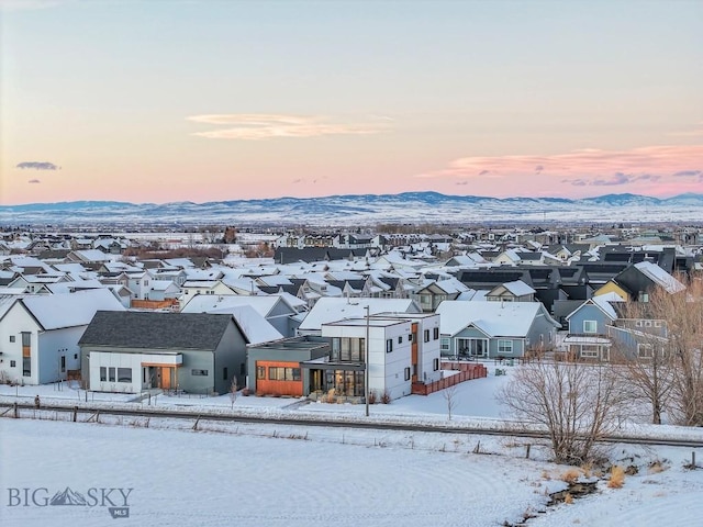 snowy aerial view featuring a mountain view