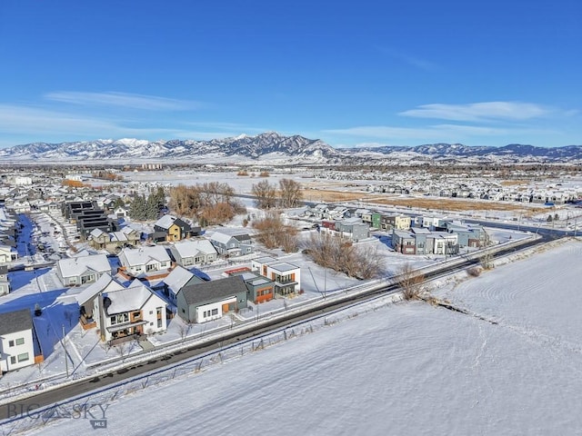 snowy aerial view with a mountain view