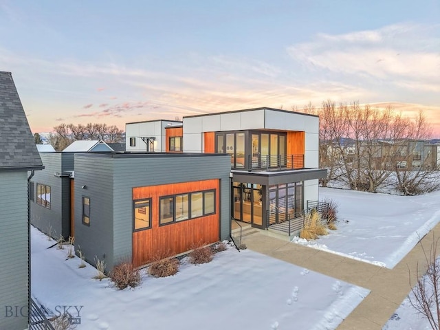 snow covered house with a balcony