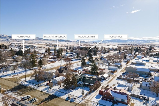 snowy aerial view featuring a mountain view