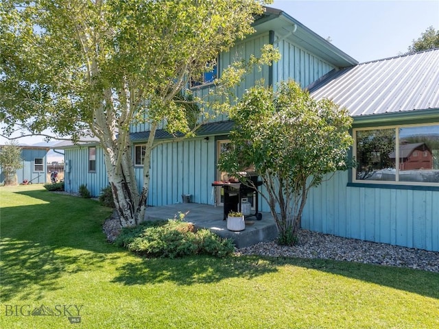 7 Hardy, Ennis, MT 59729 - rear view of house featuring board and batten siding, a yard, and metal roof