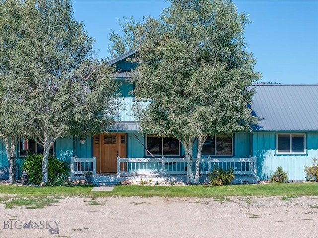 7 Hardy, Ennis, MT 59729 - view of property hidden behind natural elements with a porch, board and batten siding, and metal roof