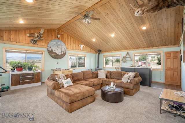 living area featuring lofted ceiling with beams, wood ceiling, ceiling fan, and light carpet