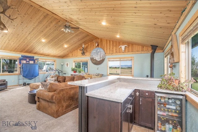 7 Hardy, Ennis, MT 59729 - kitchen featuring open floor plan, wine cooler, vaulted ceiling, wood ceiling, and dark brown cabinets