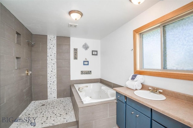 7 Hardy, Ennis, MT 59729 - full bathroom featuring a tub with jets, vanity, and a tile shower