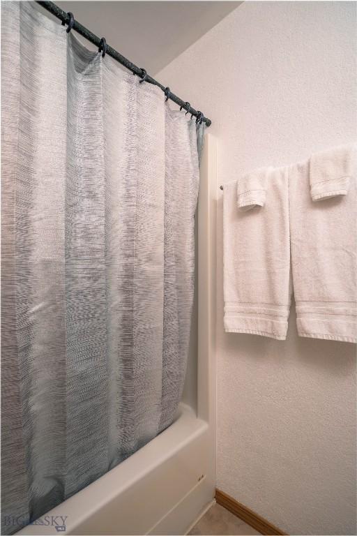 7 Hardy, Ennis, MT 59729 - bathroom with shower / bathtub combination with curtain and baseboards