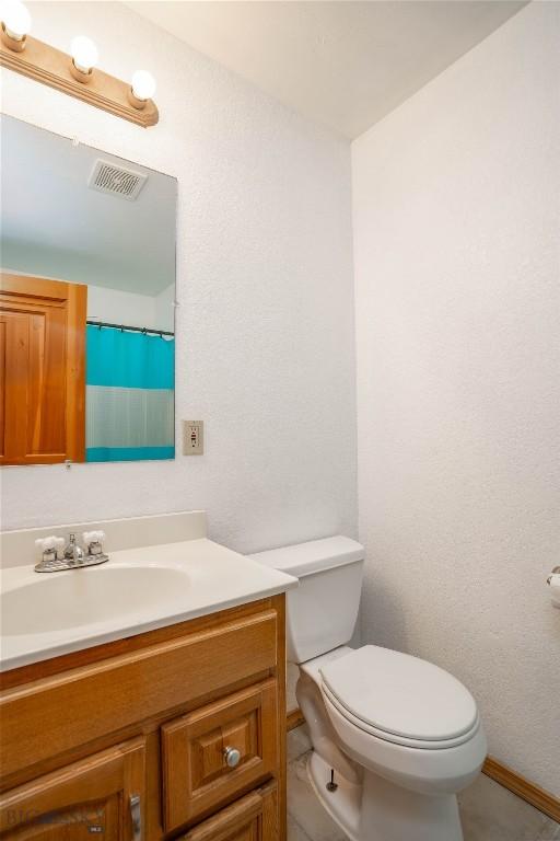 7 Hardy, Ennis, MT 59729 - bathroom with vanity, toilet, and baseboards