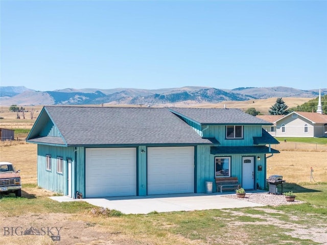 7 Hardy, Ennis, MT 59729 - view of front of property with a mountain view, roof with shingles, an attached garage, and driveway