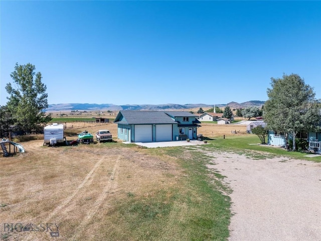 7 Hardy, Ennis, MT 59729 - view of front of home with driveway, a mountain view, and a front lawn