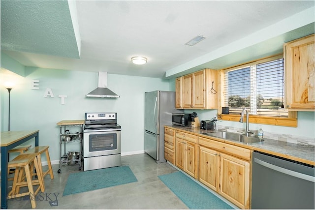 7 Hardy, Ennis, MT 59729 - kitchen with appliances with stainless steel finishes, wall chimney range hood, a sink, light brown cabinets, and concrete floors