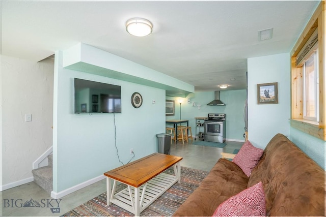7 Hardy, Ennis, MT 59729 - living room featuring concrete floors, stairs, baseboards, and a wood stove