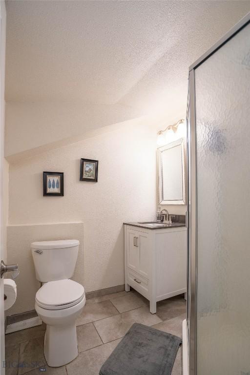 7 Hardy, Ennis, MT 59729 - full bathroom with toilet, vanity, a shower stall, and tile patterned flooring