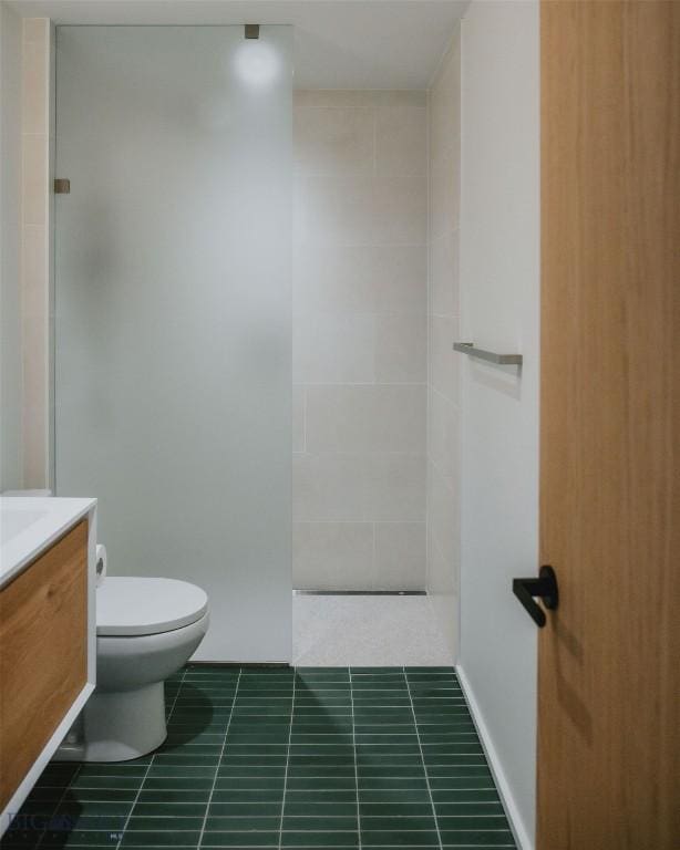 bathroom with toilet, vanity, tile patterned flooring, and a shower