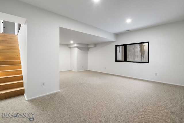 basement featuring light colored carpet