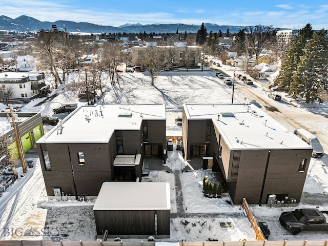 snowy aerial view with a mountain view