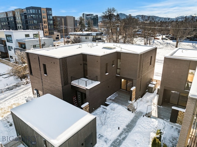 snowy aerial view featuring a mountain view