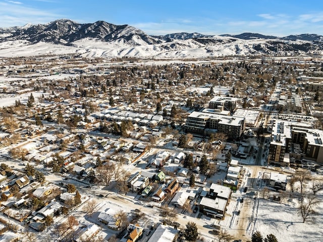 snowy aerial view with a mountain view