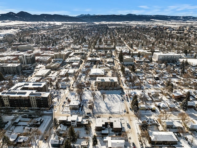 snowy aerial view featuring a mountain view