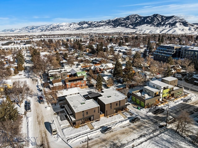 snowy aerial view featuring a mountain view