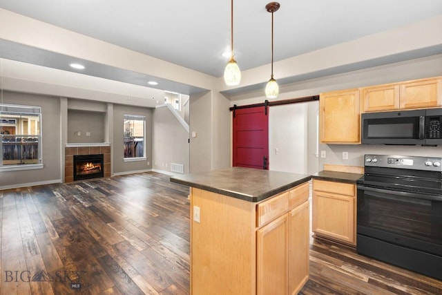 kitchen featuring a fireplace, a barn door, light brown cabinetry, and black electric range