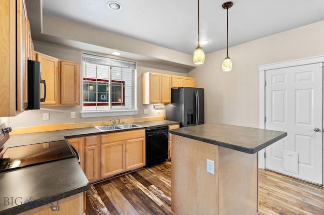 kitchen with black appliances, a center island, decorative light fixtures, sink, and dark hardwood / wood-style floors