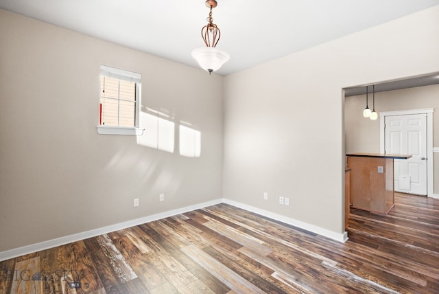 unfurnished room featuring dark hardwood / wood-style flooring