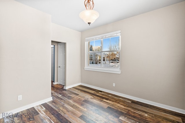 empty room with dark hardwood / wood-style flooring