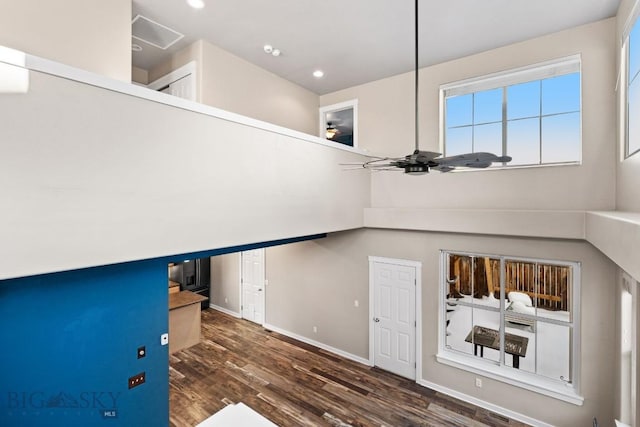 stairway with ceiling fan and hardwood / wood-style flooring