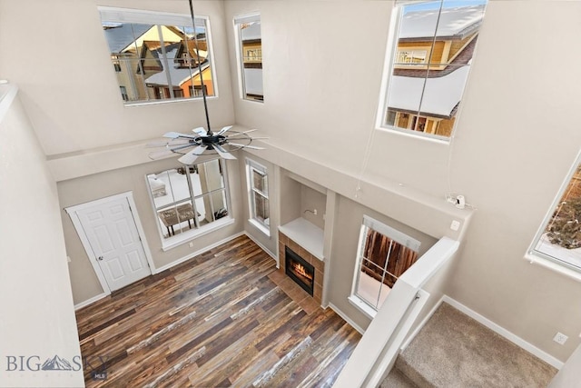 3911 Bosal St, Bozeman, MT 59718 - foyer entrance with a towering ceiling, a fireplace with flush hearth, wood finished floors, a ceiling fan, and baseboards