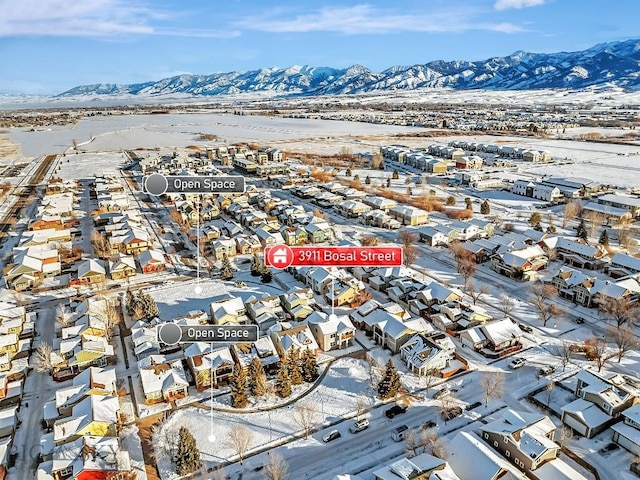 snowy aerial view featuring a mountain view