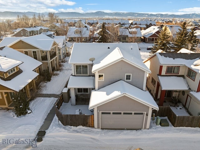 snowy aerial view featuring a mountain view