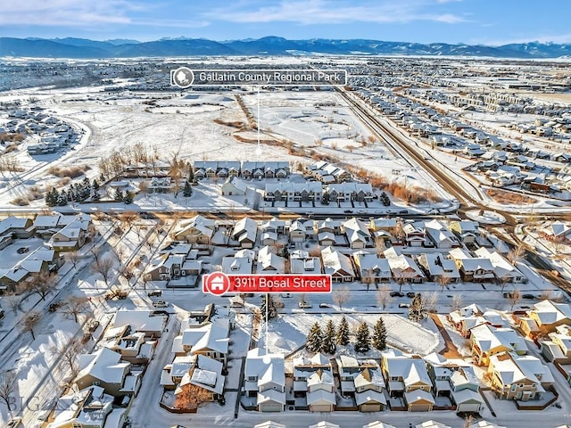 snowy aerial view featuring a mountain view